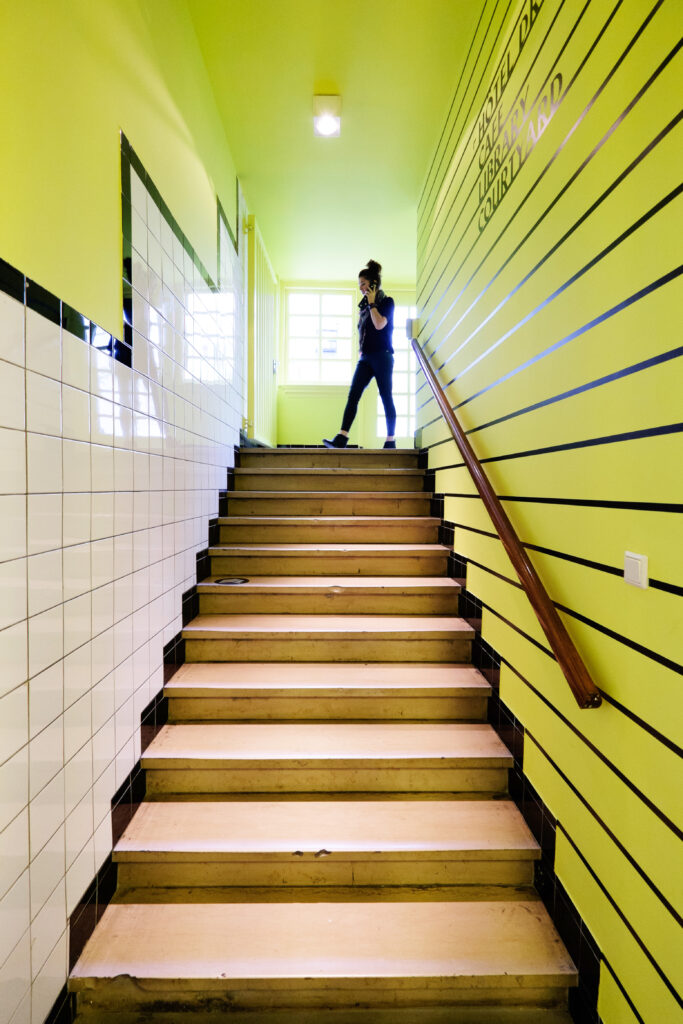 A yellow hallway thats leads to The Cafe